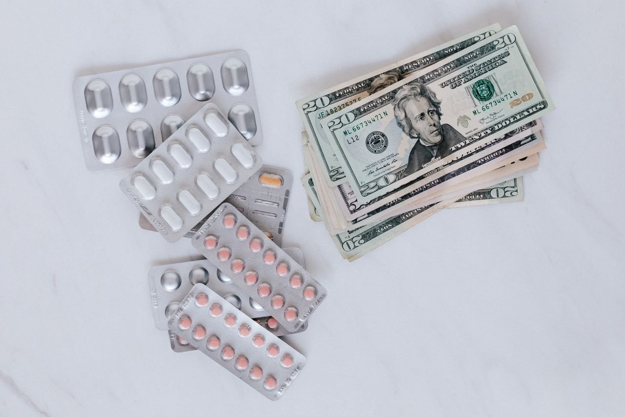 Crafting Captivating Headlines: Your awesome post title goes here From above of silver blister full of drug near big pile of dollar to spend on medication